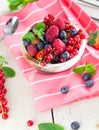 Various summer fruits in a bowl. Assorted fresh berries with lea Royalty Free Stock Photo