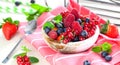 Various summer fruits in a bowl. Assorted fresh berries with lea Royalty Free Stock Photo
