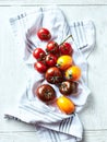 Various summer tomatoes on a kitchen towel. Top view Royalty Free Stock Photo