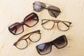 Various sunglasses set on yellow wooden background.