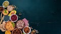 Various superfoods. Dried fruits, nuts, beans, fruits and vegetables. On a black wooden background. Royalty Free Stock Photo