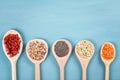 Various superfoods goji berries, quinoa, chia, hemp seeds and lantils on blue background Royalty Free Stock Photo