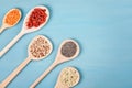 Various superfoods goji berries, quinoa, chia, hemp seeds and lantils on blue background Royalty Free Stock Photo