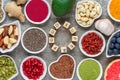 Various superfoods on gray background. matcha, acai, turmeric, fruits, berries, avocado, mushrooms, nuts and seeds Royalty Free Stock Photo