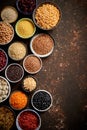 Various superfoods in smal bowls on dark rusty background