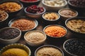 Various superfoods in smal bowls on dark rusty background