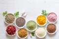 Various superfoods in small bowls on white wooden background. Healthy food concept