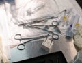 Various surgical instruments lie on the table. A sterile set of working instruments lies on the table in disarray. Table Royalty Free Stock Photo