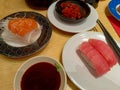 various sushi dishes on plates are served on the table Royalty Free Stock Photo