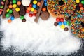 Various sweets and sugar powder as background