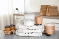 Various takeout containers on table in kitchen.