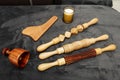 Various tools and rollers to apply wood therapy treatments on a gray velvet blanket