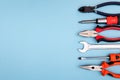 Various tools worker, hammer, wrench, screwdriver, pliers on blue background, top view with free space