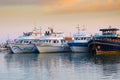 Various touristic ships and pleasure boats in the harbor at sunset. Sea port illustration Royalty Free Stock Photo