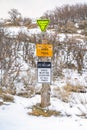 Various trail signs and dog leash sign on an old wooden post Royalty Free Stock Photo