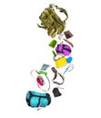 Various travel accessories falling from military backpack isolated on white background