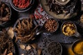 Various type of oriental earthy flavor dry spices on dark wooden table such as turmeric, black pepper, chili flake, bay leaf, for