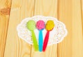 Various types baby puree in plastic spoon on light wood. Royalty Free Stock Photo