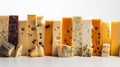 Various types of blue cheese, hard in a row. White background. AI generated.