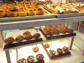 Various types of breads are displayed for sale inside the bakery display rack. Royalty Free Stock Photo