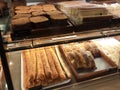 Various types of breads are displayed for sale inside the bakery display rack. Royalty Free Stock Photo