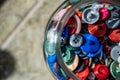assortment random colored loose buttons in a glass jar