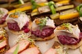 Various types of canapes with vegetables, fish and meat Royalty Free Stock Photo