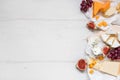 Various types of cheese with fruits on the wooden white table with copy space. Top view Royalty Free Stock Photo