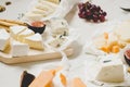 Various types of cheese with fruits on the wooden white table. Selective focus Royalty Free Stock Photo