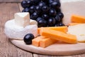 Various types of cheese on wooden background Royalty Free Stock Photo