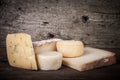 Various types of cheese on a wooden background. tinted Royalty Free Stock Photo