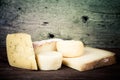 Various types of cheese on a wooden background. tinted Royalty Free Stock Photo