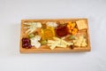 Various types of cheese on wooden cutting board Royalty Free Stock Photo