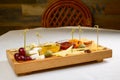 Various types of cheese on wooden cutting board Royalty Free Stock Photo