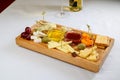 Various types of cheese on wooden cutting board Royalty Free Stock Photo
