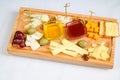Various types of cheese on wooden cutting board Royalty Free Stock Photo