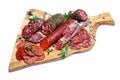 Various types of Dried organic salami sausage on wooden cutting board Royalty Free Stock Photo