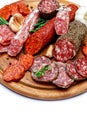 Various types of Dried organic salami sausage on wooden cutting board Royalty Free Stock Photo