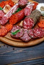 Various types of Dried organic salami sausage on wooden cutting board Royalty Free Stock Photo