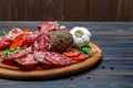 Various types of Dried organic salami sausage on wooden cutting board Royalty Free Stock Photo