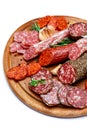 Various types of Dried organic salami sausage on wooden cutting board Royalty Free Stock Photo