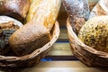 Various types of fresh bread in basket on shelf in bakery Royalty Free Stock Photo