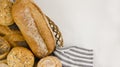 Various types of freshly baked bread and buns in a basket Royalty Free Stock Photo