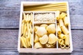 Various types of pasta in the wooden container Royalty Free Stock Photo
