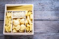 Various types of pasta in the wooden container Royalty Free Stock Photo