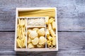 Various types of pasta in the wooden container Royalty Free Stock Photo