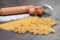 Various types or raw Italian pasta on the wooden rustic background and ingredients for pasta. Royalty Free Stock Photo