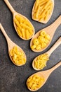 Various types of raw italian pasta in wooden spoons Royalty Free Stock Photo