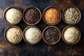 Various types of rice displayed in wooden bowls on rustic background Royalty Free Stock Photo