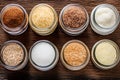 Various types of sugar in glass jars on wooden background, top view Royalty Free Stock Photo